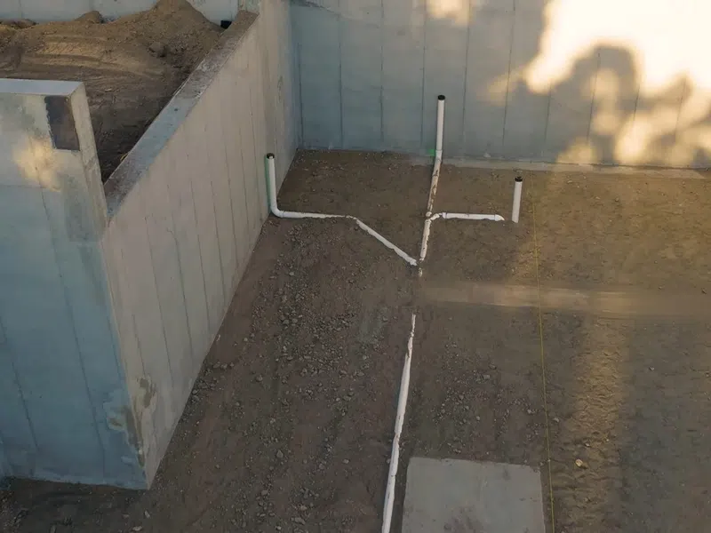 Exposed drain piping and cleanout access during plumbing rough-in work for Goodyear Monsoon Season Plumbing Prep: The West Valley Homeowner’s Checklist showing exposed drain piping cleanout access rough work monsoon prep body