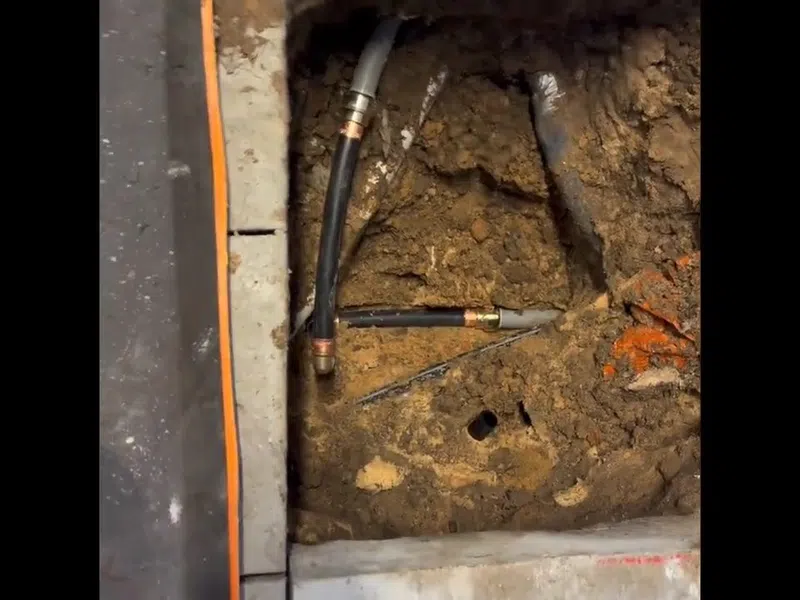 Opened slab area and leak detection equipment used to locate a hidden pipe leak for Pool Evaporation or Pool Leak? How to Tell the Difference in a Goodyear Summer showing opened slab area leak detection equipment used locate hidden pipe pool detail