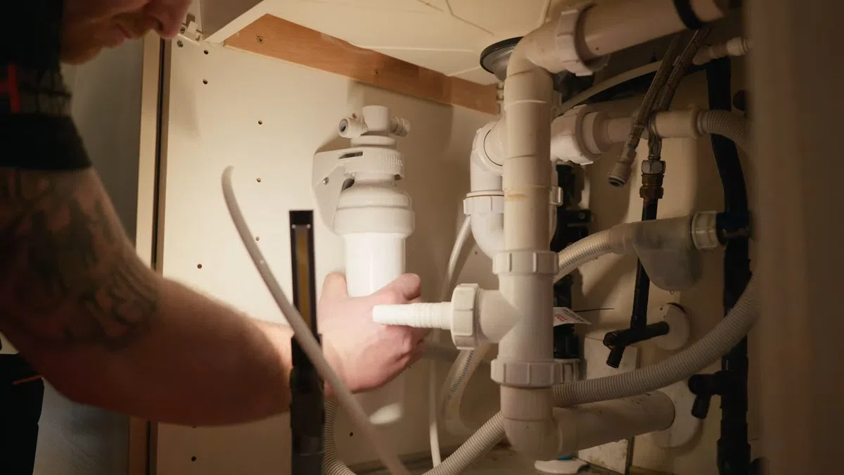 Under-sink reverse osmosis filter system connected below a kitchen sink for Why Your Goodyear RO System Is Slowing Down (And the Maintenance Schedule That Fixes