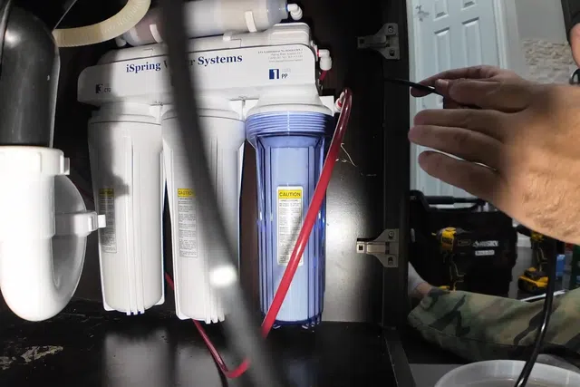 Under-sink reverse osmosis filter system connected below a kitchen sink for Plumbing Tips & Guides for West Valley Homeowners